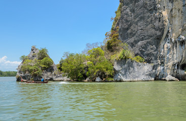 Fototapeta na wymiar Limestone mountain with long-tailed boat in Phang Nga Province, Thailand