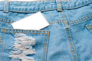 Old blue jeans and a copy space of greeting card on pocket.