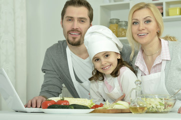 happy family cooking  in kitchen