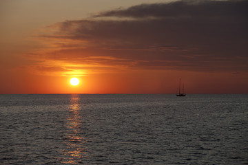 image of watercraft in sea at sunset.