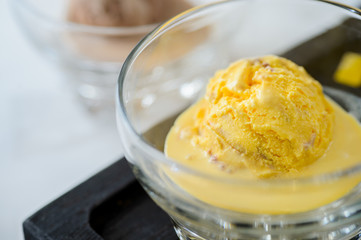 Scoop of yellow ice cream in a bowl