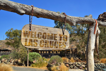 old wood signboard with text " welcome to las cruces" hanging on a branch © luzitanija