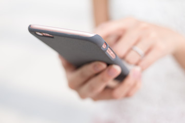 Woman sending sms on smart phone