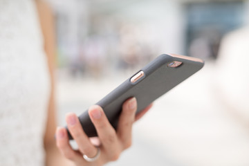 Woman sending sms on mobile phone