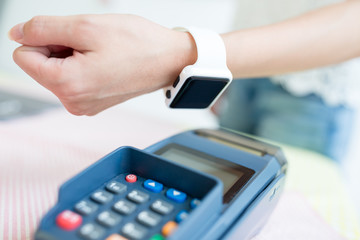 Customer paying with NFC technology with wearable watch