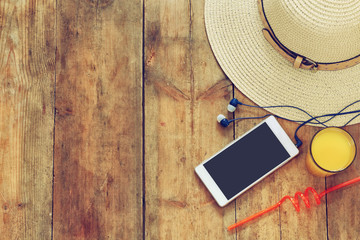 top view of summer hat, fruit cocktail and cell phone