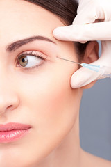 Attractive young woman is getting botox injection