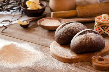 Fototapeta na wymiar Freshly baked bread, flour and cooking utensils