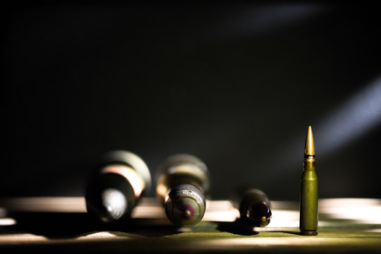 weapons, cartridge on wooden background