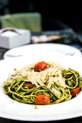 Pasta with pesto sauce and nuts on a the table