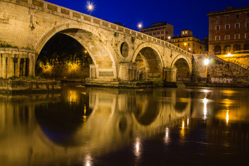 Fototapeta na wymiar Ponte Sisto bridge reflections at twilight, connecting both sides of the River Tiber, Rome, Italy, Europe