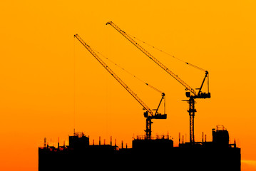 silhouettes of construction site at sunset