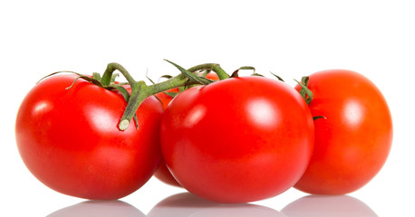 Ripe tomatoes closeup isolated on white.