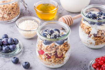 Healthy breakfast - glass jars of oat flakes with fresh fruit, y