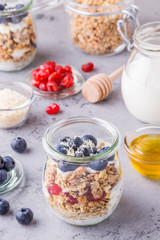 Healthy breakfast - glass jars of oat flakes with fresh fruit, y