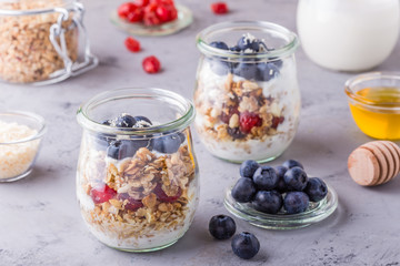 Healthy breakfast - glass jars of oat flakes with fresh fruit, y