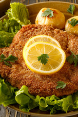 Wiener schnitzel with potatoes and salad.