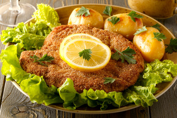 Wiener schnitzel with potatoes and salad.