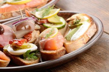 Open sandwiches with salmon, eggs, mussels, jamon and herring