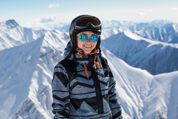 Fototapeta na wymiar Girl snowboarder on fresh white snow on ski slope on Sunny winter day