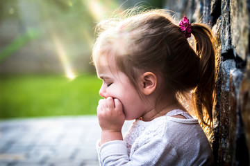 emotion girl sitting near wall in the day time