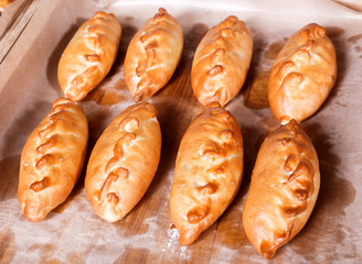 Delicious fresh pies and buns with meat and vegetables on shelf in Bakery shop. Pastries and bread in a bakery