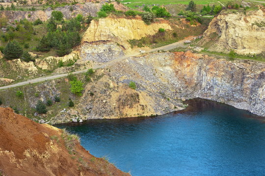 blue lake in old abandoned quarry