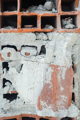 Demolished old cracked brick wall background, closeup picture. Destroy build 