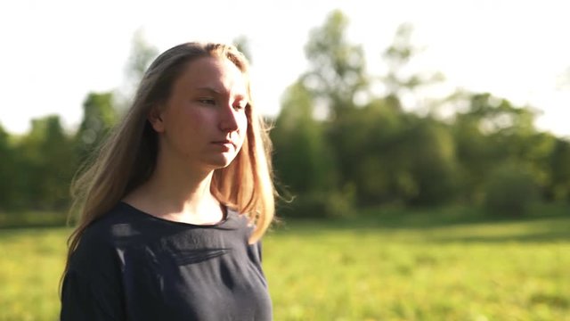 teen girl walking in park in sunset to camera shot with stabilizer, uhd prores footage