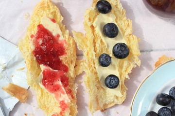 Fresh French croissants on old wooden background, romantic breakfast in the garden