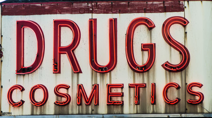 Old vintage drugs and cosmetics neon sign of an old pharmacy 