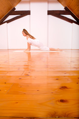 Woman practicing Yoga in a Studio..