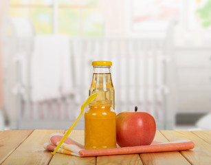 Jar  baby puree, juice bottle, apple, spoon on  background  kitchen.