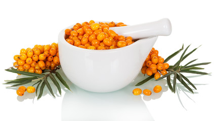 Fresh sea buckthorn berries in  mortar, pestle isolated on white.