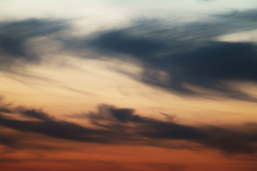 Fototapeta na wymiar dask sunset sky with clouds, orange color