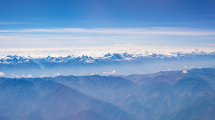 Aerial view of the Peruvian Andes, shot from aeroplane. High altitude mountain range and glaciers. Expansive view.