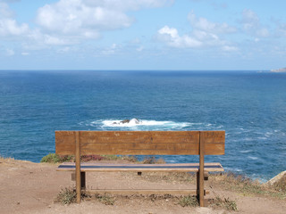 Naklejka na ściany i meble Old bench. Wooden bench overlooking the ocean