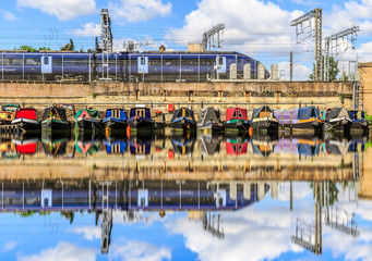 Rows of houseboats and narrow boats on the canal banks at St Pancras Yacht Basin, part of the Regent's Canal in London