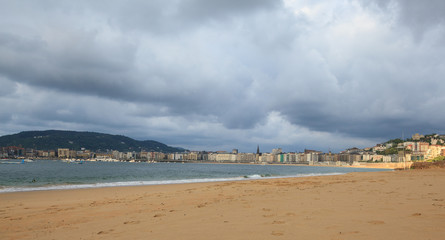 View of La Concha beach and city of San Sebastian in cloudy day, Basque Country, Spain
