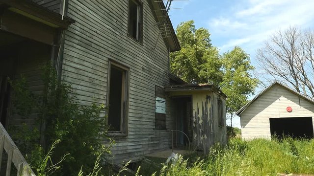 An abandoned old farm house on a shut down farm