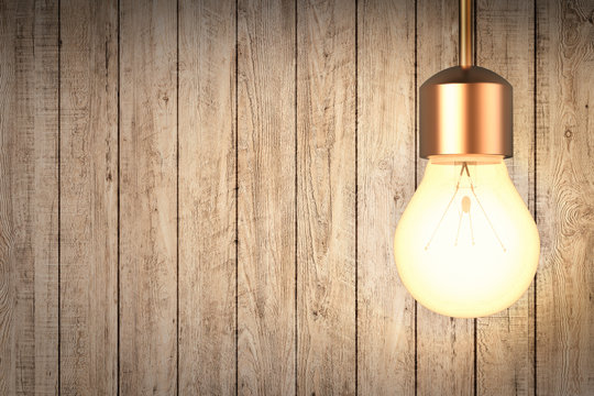 hanging light bulb with wooden wall background