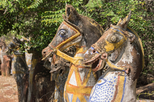 Chettinad, India - October 16, 2013: Ayyanar, village protector, Horse shrine of Namunasamudran. Two old clay horse heads are smiling. Painted bodies.