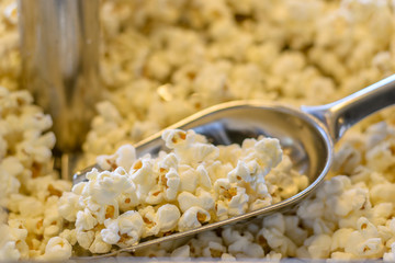 Popcorn in scoop in popcorn machine.