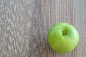 green apple on wood table