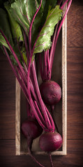Fresh beet group in wooden box and wooden table
