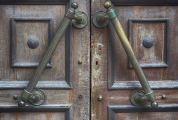 fragment of old brown door with handle and lock