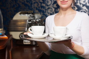 two cups of coffee on a tray