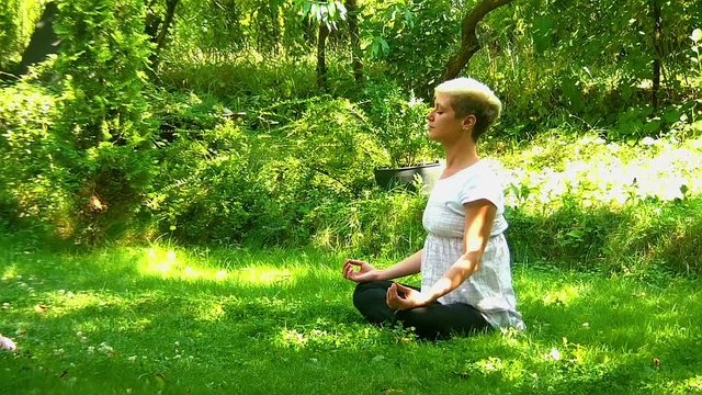 Modern woman meditating in nature 