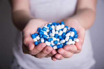 close up of pills in female hands