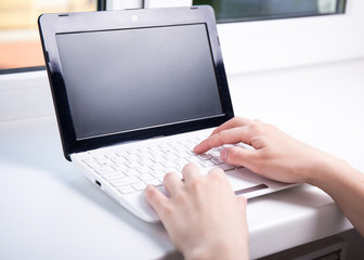 woman using laptop with blank screen